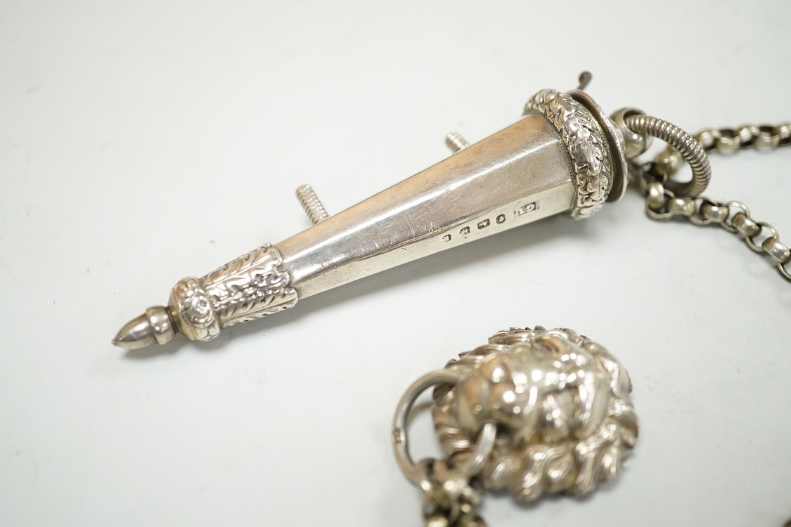 A Victorian silver whistle and case by George Unite, Birmingham, 1860, 93mm, suspended from a white metal chain with lion mask mount.